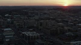 5.7K aerial stock footage ascend and fly away from hospital with view of setting sun, Nashville, Tennessee Aerial Stock Footage | DX0002_115_015