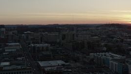 5.7K aerial stock footage descend near a hospital complex with view of setting sun, Nashville, Tennessee Aerial Stock Footage | DX0002_115_016