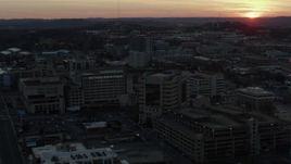 5.7K aerial stock footage approach hospital complex and ascend with view of setting sun, Nashville, Tennessee Aerial Stock Footage | DX0002_115_017
