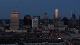 5.7K aerial stock footage flying by skyscrapers reflecting light in the city skyline at twilight in Downtown Nashville, Tennessee Aerial Stock Footage | DX0002_115_026