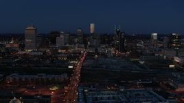 5.7K aerial stock footage reverse view of Church Street and city skyline at twilight, Downtown Nashville, Tennessee Aerial Stock Footage | DX0002_115_036