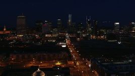 5.7K aerial stock footage fly away from the city skyline at night, reveal flashing lights on Church Street, Downtown Nashville, Tennessee Aerial Stock Footage | DX0002_115_052