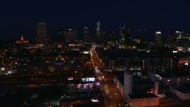 5.7K aerial stock footage the city skyline at night while passing flashing lights on Church Street, Downtown Nashville, Tennessee Aerial Stock Footage | DX0002_115_053
