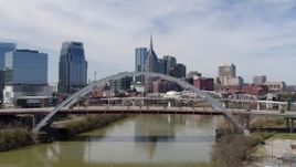 5.7K aerial stock footage stationary view of bridge and skyscrapers in Downtown Nashville, Tennessee Aerial Stock Footage | DX0002_116_009