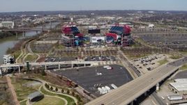 5.7K aerial stock footage reverse view of Nissan Stadium seen from a bridge in Nashville, Tennessee Aerial Stock Footage | DX0002_116_018