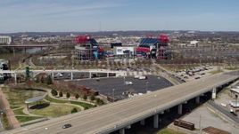 5.7K aerial stock footage of Nissan Stadium while ascending near a bridge in Nashville, Tennessee Aerial Stock Footage | DX0002_116_020