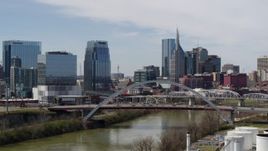 5.7K aerial stock footage approach river and bridge, and skyscrapers near the Cumberland River in Downtown Nashville, Tennessee Aerial Stock Footage | DX0002_116_029