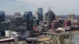 5.7K aerial stock footage flyby Cumberland River and bridge, closer view of office high-rise and skyscrapers in Downtown Nashville, Tennessee Aerial Stock Footage | DX0002_116_030