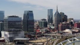 5.7K aerial stock footage descend and orbit office high-rise and skyscrapers, seen from the river in Downtown Nashville, Tennessee Aerial Stock Footage | DX0002_116_031