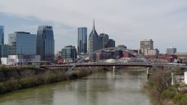5.7K aerial stock footage flyby and approach bridge on Cumberland River near skyscrapers in Downtown Nashville, Tennessee Aerial Stock Footage | DX0002_116_033