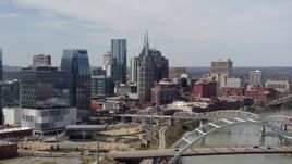 5.7K aerial stock footage of the AT&T Building seen while flying by a bridge and the river in Downtown Nashville, Tennessee Aerial Stock Footage | DX0002_116_037
