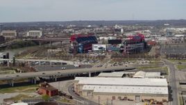5.7K aerial stock footage slowly flying away from Nissan Stadium near bridge in Nashville, Tennessee Aerial Stock Footage | DX0002_116_041