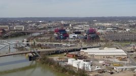 5.7K aerial stock footage wide orbit of Nissan Stadium near bridge, seen from Cumberland River in Nashville, Tennessee Aerial Stock Footage | DX0002_116_043