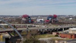 5.7K aerial stock footage reverse view of Nissan Stadium behind the bridge in Nashville, Tennessee Aerial Stock Footage | DX0002_116_045