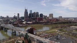 5.7K aerial stock footage of the city's riverfront skyscrapers seen from the pedestrian bridge, Downtown Nashville, Tennessee Aerial Stock Footage | DX0002_117_002