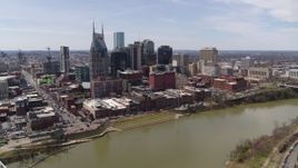 5.7K aerial stock footage reverse view of the city's riverfront skyscrapers by the Cumberland River, Downtown Nashville, Tennessee Aerial Stock Footage | DX0002_117_006