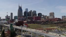 5.7K aerial stock footage city's skyline overlooking the Cumberland River, descend and flyby pedestrian bridge, Downtown Nashville, Tennessee Aerial Stock Footage | DX0002_117_023
