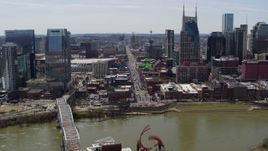 5.7K aerial stock footage busy Broadway across the Cumberland River, Downtown Nashville, Tennessee Aerial Stock Footage | DX0002_117_030