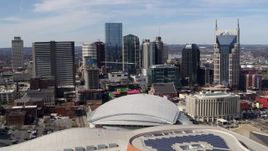 5.7K aerial stock footage passing the city's skyline behind the arena and hotel, Downtown Nashville, Tennessee Aerial Stock Footage | DX0002_117_040