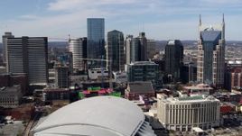 5.7K aerial stock footage flyby and approach city's skyline behind the arena and hotel, Downtown Nashville, Tennessee Aerial Stock Footage | DX0002_117_041