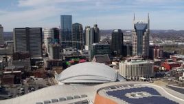 5.7K aerial stock footage fly away from and past the city's skyline, Bridgestone Arena, and Hilton hotel, Downtown Nashville, Tennessee Aerial Stock Footage | DX0002_117_051