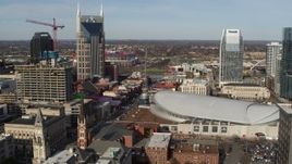 5.7K aerial stock footage flyby top of hotel to reveal Broadway and Bridgestone Arena in Downtown Nashville, Tennessee Aerial Stock Footage | DX0002_119_007