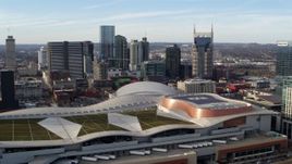 5.7K aerial stock footage of the city's skyline before flying away from Nashville Music City Center, Downtown Nashville, Tennessee Aerial Stock Footage | DX0002_119_024