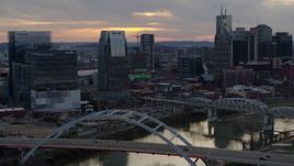 5.7K aerial stock footage approach Pinnacle skyscraper and a bridge on the river at sunset, Downtown Nashville, Tennessee Aerial Stock Footage | DX0002_120_017