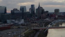 5.7K aerial stock footage approach riverfront skyscrapers by the Cumberland River at sunset, Downtown Nashville, Tennessee Aerial Stock Footage | DX0002_120_019