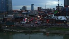 5.7K aerial stock footage of flying by Broadway during ascent at twilight, Downtown Nashville, Tennessee Aerial Stock Footage | DX0002_120_020