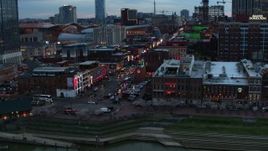 5.7K aerial stock footage of flying by Broadway at twilight, Downtown Nashville, Tennessee Aerial Stock Footage | DX0002_120_021