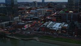 5.7K aerial stock footage of a reverse view of Broadway during ascent at twilight, Downtown Nashville, Tennessee Aerial Stock Footage | DX0002_120_022