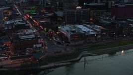 5.7K aerial stock footage of buildings, cars and pedestrians around Broadway at twilight, Downtown Nashville, Tennessee Aerial Stock Footage | DX0002_120_026