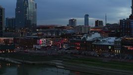 5.7K aerial stock footage approach riverfront buildings, cars on Broadway at twilight, Downtown Nashville, Tennessee Aerial Stock Footage | DX0002_120_028