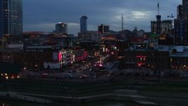 5.7K aerial stock footage descend and flyby traffic and riverfront buildings on Broadway at twilight, Downtown Nashville, Tennessee Aerial Stock Footage | DX0002_120_033