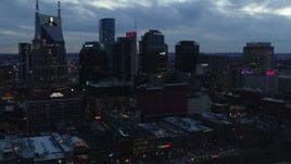 5.7K aerial stock footage ascend while flying by tall skyscrapers near AT&T Building at twilight, Downtown Nashville, Tennessee Aerial Stock Footage | DX0002_120_035
