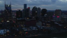 5.7K aerial stock footage flying by the AT&T Building and tall skyscrapers at twilight, Downtown Nashville, Tennessee Aerial Stock Footage | DX0002_120_036