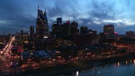 5.7K aerial stock footage of flying by the city's skyline at twilight and reveal Broadway, Downtown Nashville, Tennessee Aerial Stock Footage | DX0002_121_001