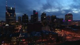 5.7K aerial stock footage of passing by the city's skyline at twilight, Downtown Nashville, Tennessee Aerial Stock Footage | DX0002_121_002