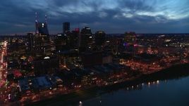 5.7K aerial stock footage of crossing the river toward the city's skyline at twilight, Downtown Nashville, Tennessee Aerial Stock Footage | DX0002_121_004
