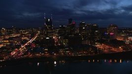 5.7K aerial stock footage flying away from the AT&T Building and skyline at twilight, reveal the river, Downtown Nashville, Tennessee Aerial Stock Footage | DX0002_121_013