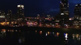 5.7K aerial stock footage approach the end of Broadway with traffic at twilight, descend by the river in Downtown Nashville, Tennessee Aerial Stock Footage | DX0002_121_022