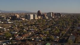 5.7K aerial stock footage of the city's high-rises seen from neighborhoods during descent, Downtown Albuquerque, New Mexico Aerial Stock Footage | DX0002_122_005