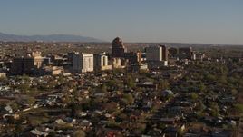 5.7K aerial stock footage of slowly passing by the city's high-rises, seen from neighborhoods, Downtown Albuquerque, New Mexico Aerial Stock Footage | DX0002_122_009