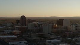 5.7K aerial stock footage of high-rise office buildings at sunset during ascent in Downtown Albuquerque, New Mexico Aerial Stock Footage | DX0002_122_031