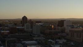 5.7K aerial stock footage fly away from high-rise office buildings at sunset and ascend past Downtown Albuquerque, New Mexico Aerial Stock Footage | DX0002_122_034