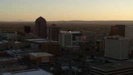 5.7K aerial stock footage of high-rise office buildings at sunset during descent and flying away, Downtown Albuquerque, New Mexico Aerial Stock Footage | DX0002_122_040