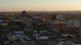 5.7K aerial stock footage of a reverse view of high-rise office buildings at sunset and ascend, Downtown Albuquerque, New Mexico Aerial Stock Footage | DX0002_122_042