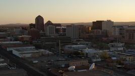 5.7K aerial stock footage fly away from office high-rises at sunset during descent, Downtown Albuquerque, New Mexico Aerial Stock Footage | DX0002_122_046