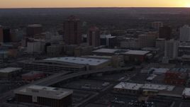 5.7K aerial stock footage slow orbit of an office tower and shorter hotel tower behind convention center at sunset, Downtown Albuquerque, New Mexico Aerial Stock Footage | DX0002_122_050